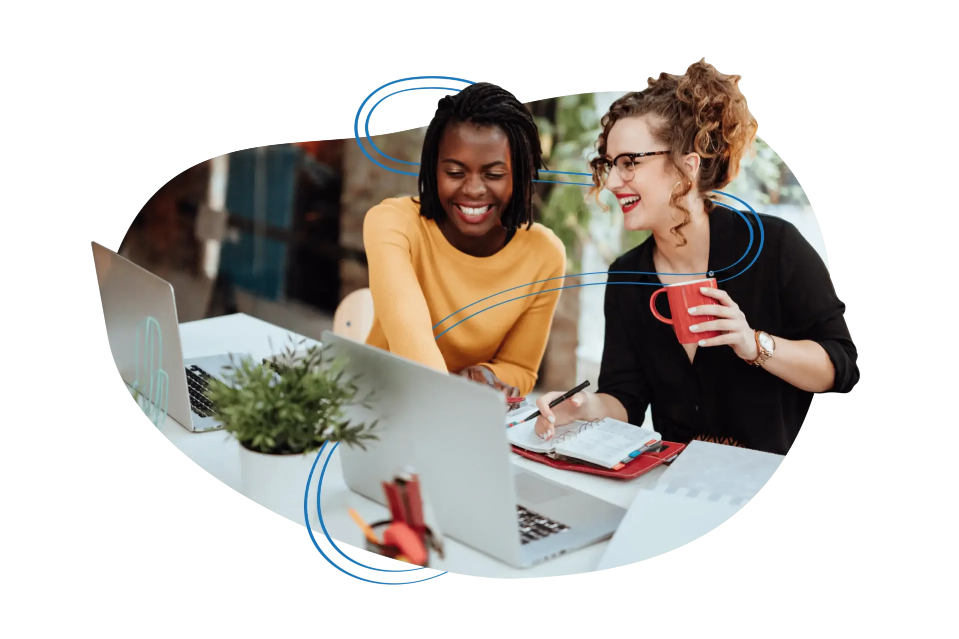 Two females on a laptop computer smiling